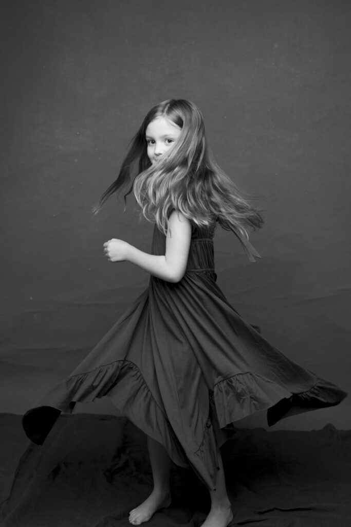 girl in a studio twirling for the camera