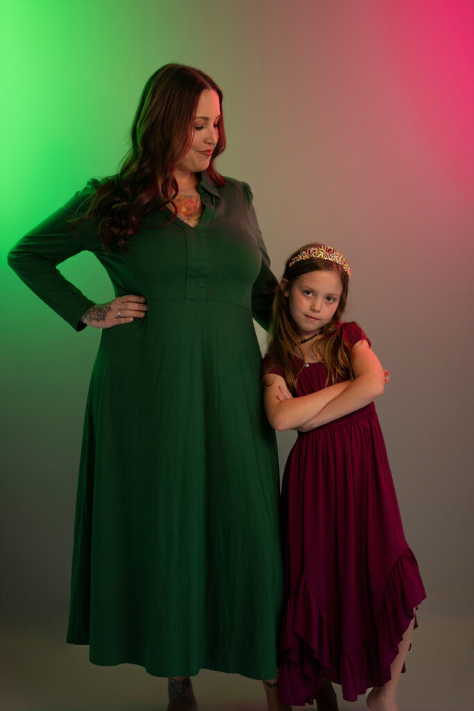mother and daughter wearing green and pink in photo studio